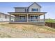 Charming two-story home featuring a covered porch and neutral gray paint scheme at 9051 Telluride Ct, Commerce City, CO 80022