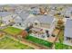 Beautiful aerial view of a home featuring a fenced yard, pergola-covered patio, and proximity to neighborhood amenities at 12873 E 108Th Ave, Commerce City, CO 80022