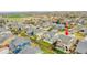 This aerial shot showcases the property's location within a vibrant neighborhood and green space at 12873 E 108Th Ave, Commerce City, CO 80022