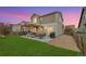 Well-maintained backyard includes a lawn, stone landscaping, patio, and a grill, perfect for outdoor enjoyment at 12873 E 108Th Ave, Commerce City, CO 80022