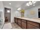 Bathroom with a double sink vanity, large mirror, and a walk-in shower with tiled walls and floor at 12873 E 108Th Ave, Commerce City, CO 80022