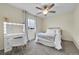 Cozy bedroom with a makeup vanity and a bed with white linen and a window for natural light at 12873 E 108Th Ave, Commerce City, CO 80022