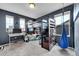 Bedroom with a loft bed, study desk, and a hanging swing seat, illuminated by natural light from two windows at 12873 E 108Th Ave, Commerce City, CO 80022
