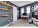 Bedroom features shelves with toys, a study desk, and is illuminated by natural light from two windows at 12873 E 108Th Ave, Commerce City, CO 80022