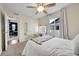 Another bedroom featuring a makeup vanity, a bed with white linen and a window for natural light at 12873 E 108Th Ave, Commerce City, CO 80022