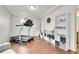 Spacious bonus room with hardwood floors, storage shelves, and a treadmill for a convenient home gym at 12873 E 108Th Ave, Commerce City, CO 80022