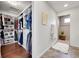 Walk-in closet with built-in shelving for shoes and clothes, and a view of the bathroom with a standing shower at 12873 E 108Th Ave, Commerce City, CO 80022
