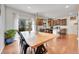 A dining area with a large table, chairs and access to kitchen and back patio at 12873 E 108Th Ave, Commerce City, CO 80022