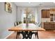 A bright dining room featuring a large table with black chairs and view to the backyard at 12873 E 108Th Ave, Commerce City, CO 80022