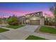 Charming two-story home boasts a well-maintained lawn, inviting front porch and a two car garage with a long driveway at 12873 E 108Th Ave, Commerce City, CO 80022
