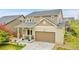 Inviting exterior showcasing a covered front porch, lush green lawn, and a two-car garage, complemented by the mature landscaping at 12873 E 108Th Ave, Commerce City, CO 80022