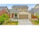 Inviting home exterior with a covered porch, lush lawn, and a two-car garage offering comfort and convenience at 12873 E 108Th Ave, Commerce City, CO 80022