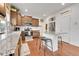 Spacious kitchen with granite countertops, stainless appliances, island with bar stools and pantry at 12873 E 108Th Ave, Commerce City, CO 80022