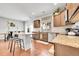 Well-lit kitchen featuring granite countertops, stainless steel appliances, and beautiful wood cabinetry at 12873 E 108Th Ave, Commerce City, CO 80022