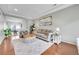 Bright living room with hardwood floors, a comfortable sofa, plants and stylish rug provides a cozy and inviting atmosphere at 12873 E 108Th Ave, Commerce City, CO 80022