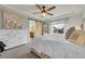 Comfortable main bedroom boasts an ensuite bathroom with a sliding barn door and dresser storage at 12873 E 108Th Ave, Commerce City, CO 80022
