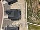Aerial view of a home with a dark roof, xeriscaping, and dirt lot at 1672 Fox Trotter Pt, Castle Rock, CO 80104