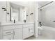 Bright bathroom with double sink vanity, quartz countertops, and tiled shower and tub at 1672 Fox Trotter Pt, Castle Rock, CO 80104