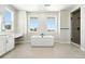 Clean bathroom design featuring a modern tub, walk-in shower with a window, and a vanity area at 1672 Fox Trotter Pt, Castle Rock, CO 80104