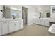 Modern bathroom with double vanity, large mirrors, and tile flooring at 1672 Fox Trotter Pt, Castle Rock, CO 80104