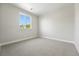 A bright bedroom with neutral carpet and baseboards with a window view at 1672 Fox Trotter Pt, Castle Rock, CO 80104