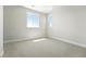 Bright bedroom with neutral carpet, baseboards and two windows at 1672 Fox Trotter Pt, Castle Rock, CO 80104