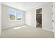 Bright bedroom with two large windows, neutral carpet and en-suite bathroom at 1672 Fox Trotter Pt, Castle Rock, CO 80104
