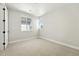 Bright bedroom with neutral carpet, white trim and two windows at 1672 Fox Trotter Pt, Castle Rock, CO 80104