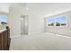 Bright, spacious bonus room featuring plush carpet, neutral paint, and natural light from three large windows at 1672 Fox Trotter Pt, Castle Rock, CO 80104