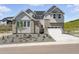 Charming home with gray siding, stone accents, well maintained front yard, and a driveway at 1672 Fox Trotter Pt, Castle Rock, CO 80104
