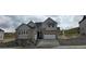 Beautiful two story home featuring a stone and siding exterior with an attached two car garage and professionally landscaped yard at 1672 Fox Trotter Pt, Castle Rock, CO 80104