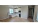 Open concept kitchen with stainless steel appliances, modern white cabinets, and large island with quartz countertops at 1672 Fox Trotter Pt, Castle Rock, CO 80104