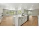 Modern kitchen with island, stainless steel appliances, and open living space at 1672 Fox Trotter Pt, Castle Rock, CO 80104