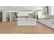 Modern kitchen with island, open living space, and bright white cabinetry at 1672 Fox Trotter Pt, Castle Rock, CO 80104