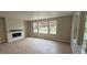 Bright living room with hardwood floors, fireplace, and large windows offering views of the surrounding landscape at 1672 Fox Trotter Pt, Castle Rock, CO 80104