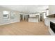Spacious living room area with natural light, light-colored wood-look floors and open floor plan at 1672 Fox Trotter Pt, Castle Rock, CO 80104