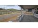 Covered patio with white railing overlooking a hillside, providing a relaxing outdoor space at 1672 Fox Trotter Pt, Castle Rock, CO 80104