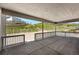 Covered patio with wood ceiling and railing overlooking a green and scenic background at 1672 Fox Trotter Pt, Castle Rock, CO 80104