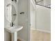 Elegant powder room with pedestal sink, modern fixtures, and a decorative oval mirror at 1672 Fox Trotter Pt, Castle Rock, CO 80104