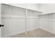 Empty walk-in closet featuring neutral carpet, white walls and metal shelves at 1672 Fox Trotter Pt, Castle Rock, CO 80104