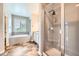 Bright primary bathroom featuring soaking tub, granite countertop, double sinks and a walk-in shower at 606 E Dry Creek Pl, Littleton, CO 80122