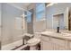Bathroom featuring a frameless glass shower, tile floors, and granite countertop at 606 E Dry Creek Pl, Littleton, CO 80122