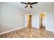 This bedroom has an open closet and beautiful wood floors with two open doorways at 606 E Dry Creek Pl, Littleton, CO 80122
