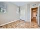 Bedroom featuring wood floors, a closet, natural light and neutral paint at 606 E Dry Creek Pl, Littleton, CO 80122