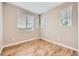 Bedroom featuring wood floors, a large window and natural light at 606 E Dry Creek Pl, Littleton, CO 80122