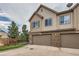 Townhome exterior with brick and siding, featuring attached two-car garages and landscaping at 606 E Dry Creek Pl, Littleton, CO 80122