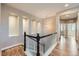 Upper hallway features built in wall niches, wood floors, and a pendant light at 606 E Dry Creek Pl, Littleton, CO 80122