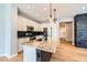 Modern kitchen with granite countertops, stainless appliances, and black splash at 606 E Dry Creek Pl, Littleton, CO 80122
