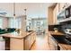 Modern kitchen with granite countertops, stainless appliances, and open-concept layout at 606 E Dry Creek Pl, Littleton, CO 80122