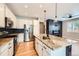 Modern kitchen featuring stainless steel appliances, white cabinets, and granite countertops at 606 E Dry Creek Pl, Littleton, CO 80122